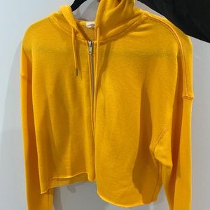 A yellow cropped hoodie.